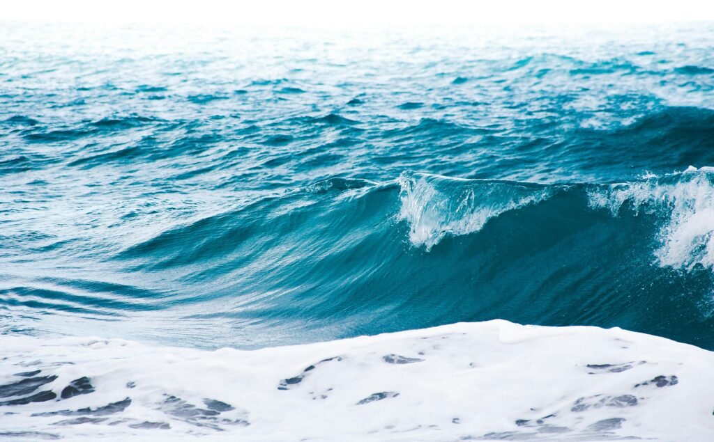 A stunning view of ocean waves crashing with vibrant blue hues off the coast of Brazil.